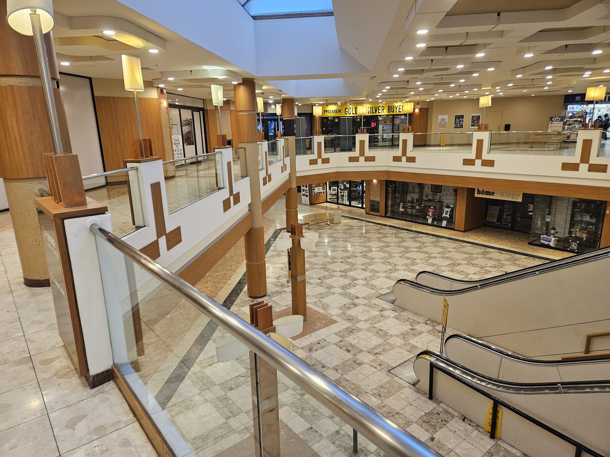 Upper-level atrium balcony with light timber trim and skylight above the Peterborough Square food court